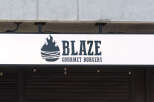 Discover a prime commercial space perfect for a restaurant or retail business, featuring prominent signage for 'Blaze Gourmet Burgers'.