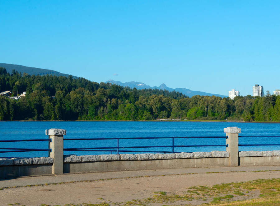 Experience breathtaking waterfront living with this stunning property offering panoramic views of the serene blue waters and lush green mountains.