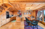 Experience rustic charm in this beautifully appointed wooden chalet kitchen and dining area.