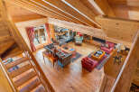 Experience the cozy charm of this rustic mountain retreat, featuring a grand stone fireplace as the centerpiece of the living area.