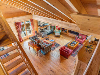 Experience the cozy charm of this rustic mountain retreat, featuring a grand stone fireplace as the centerpiece of the living area.