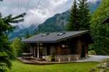 Experience serene mountain living in this charming wooden cabin nestled amidst lush greenery.