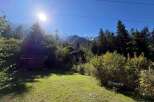 Nestled amidst lush greenery and towering trees, this property offers a serene mountain retreat.