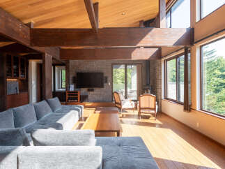 Experience luxurious living in this stunning home featuring a spacious living area with a large sectional sofa and a cozy seating arrangement.