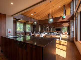 Experience luxurious living in this stunning open-concept space, featuring a modern kitchen island with a sleek countertop and integrated sink.