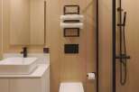 Experience modern comfort in this sleek bathroom featuring a floating vanity with a vessel sink and a matte black faucet.