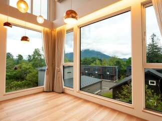 Experience breathtaking mountain views from this stunning modern home, featuring expansive floor-to-ceiling windows that flood the space with natural light.
