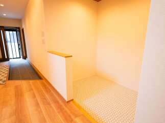 Step into a welcoming entryway featuring warm wooden floors and a stylish tiled area, perfect for greeting guests.