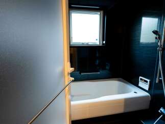 Experience modern comfort in this sleek bathroom featuring a deep soaking tub, perfect for unwinding after a long day.