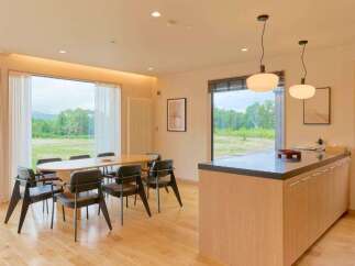 Experience modern living with this stunning dining area featuring a large oval table and comfortable chairs, perfect for family gatherings.