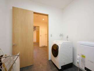 This laundry room features a modern front-loading washing machine and a dryer, perfect for handling your household chores efficiently.