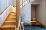Experience modern living with this beautifully designed staircase, featuring warm wooden treads and integrated LED lighting for a sophisticated ambiance.