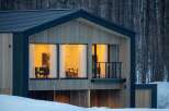 Experience modern living in this stunning home, featuring a striking architectural design with vertical wood paneling and dark blue accents.