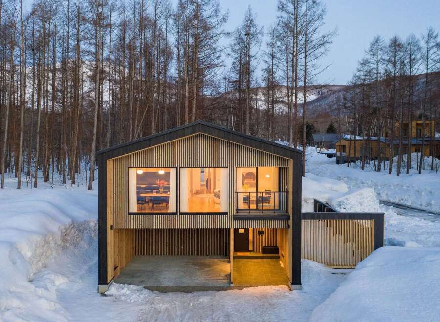 Experience modern living nestled in a serene winter wonderland.