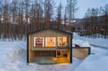 Experience modern living nestled in a serene winter wonderland.