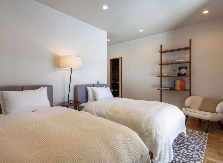 This inviting bedroom features two comfortable twin beds, perfect for guests or a shared space.
