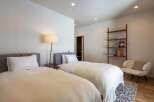 This inviting bedroom features two comfortable twin beds, perfect for guests or a shared space.
