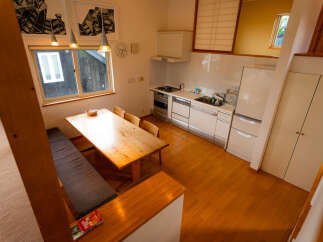 This charming dining area features a rustic wooden table with a built-in bench, perfect for cozy meals.