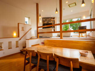 Experience comfortable living in this multi-level home featuring a spacious dining area with a wooden table and chairs, perfect for family meals.