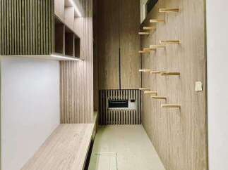 Discover modern living with this sleek, minimalist design featuring integrated wooden slat walls and built-in shelving.