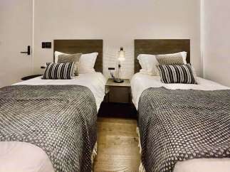 This inviting bedroom features two comfortable twin beds, perfect for accommodating guests or family.