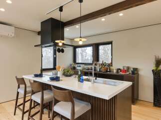 Experience modern living in this stylish kitchen featuring a sleek island with a built-in sink and ample counter space.