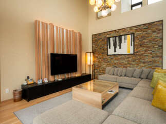 Experience modern living in this spacious living room, featuring a large sectional sofa perfect for gatherings.