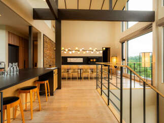 Experience modern luxury in this spacious open-plan living area, featuring a sleek kitchen island with bar stools and a stunning dining space.
