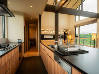 Experience modern living in this stunning kitchen featuring sleek wooden cabinetry and a spacious island perfect for meal preparation and entertaining.