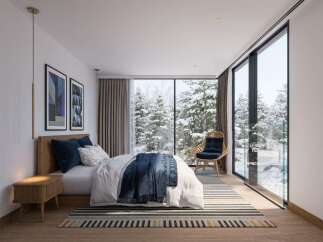 Experience serene winter living in this modern bedroom, featuring a cozy bed adorned with plush navy pillows and a textured throw blanket.