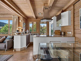 Experience rustic charm and modern convenience in this stunning mountain chalet kitchen.