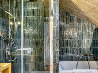 Experience a spa-like retreat in this modern bathroom, featuring a sleek glass shower enclosure and a luxurious bathtub.