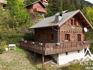 Nestled in a serene mountain setting, this charming wooden chalet offers a picturesque retreat.