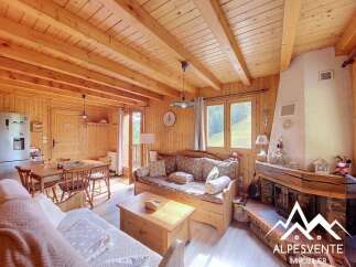 Experience rustic charm in this cozy mountain retreat, featuring exposed wooden beams and a warm, inviting fireplace.