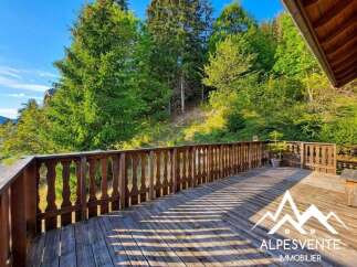 Enjoy the serene mountain views from this spacious wooden deck, perfect for outdoor living and entertaining.