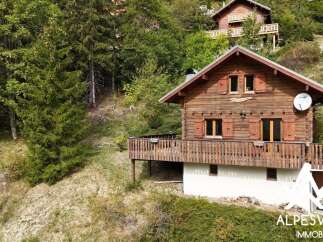 Nestled amidst lush greenery, this charming wooden chalet offers a serene mountain retreat.