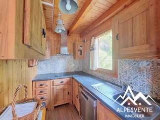 Discover this charming kitchen featuring rustic wooden cabinetry and a tiled backsplash, perfect for a cozy mountain retreat.