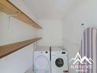 This laundry room features two appliances, a dryer and a washing machine, perfect for handling your household chores.