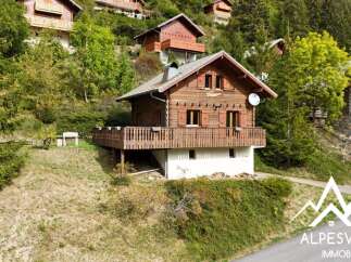 Discover this charming wooden chalet nestled in a serene mountain setting, perfect for a tranquil getaway.