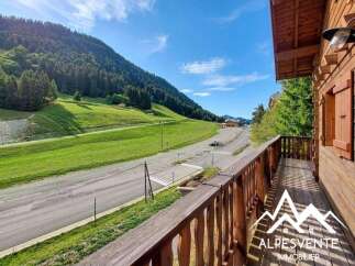 Experience breathtaking mountain views from this charming wooden chalet, complete with a spacious balcony perfect for enjoying the alpine scenery.