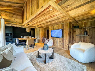 Experience luxurious alpine living in this stunning chalet-style apartment, featuring a warm and inviting ambiance with natural wood finishes throughout.