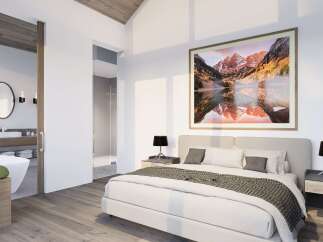 Experience luxury in this master suite featuring a king-sized bed adorned with plush linens and a decorative throw.