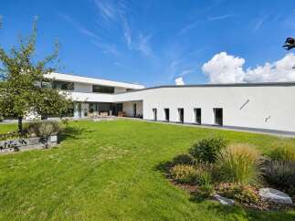 Discover modern architectural elegance in this stunning property, featuring clean lines and expansive glass windows that seamlessly blend indoor and outdoor living.