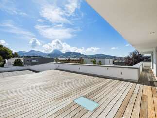 Experience breathtaking mountain views from this expansive modern terrace, perfect for outdoor living and entertaining.