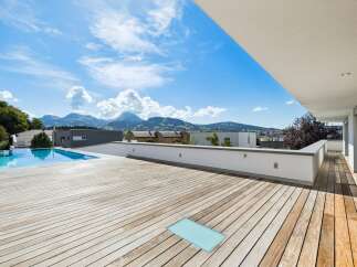 Experience breathtaking mountain views from this expansive modern terrace, perfect for outdoor living and entertaining.