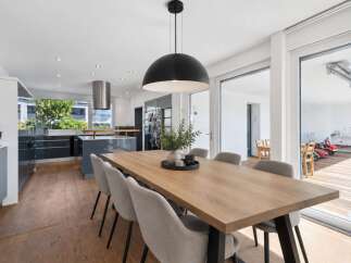 Experience modern living in this spacious open-plan kitchen and dining area, perfect for entertaining.