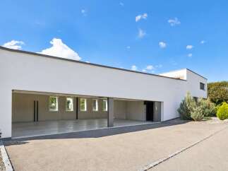 Discover modern living with this spacious, open-plan garage and adjacent contemporary home.