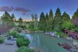 Escape to your private oasis with this stunning backyard featuring a serene pond and lush landscaping.