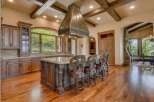 Experience luxury in this stunning gourmet kitchen, featuring custom dark wood cabinetry and a grand granite-topped island perfect for entertaining.