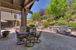 Experience luxurious outdoor living with this stunning patio featuring a built-in gourmet grill and a cozy dining area perfect for al fresco meals.